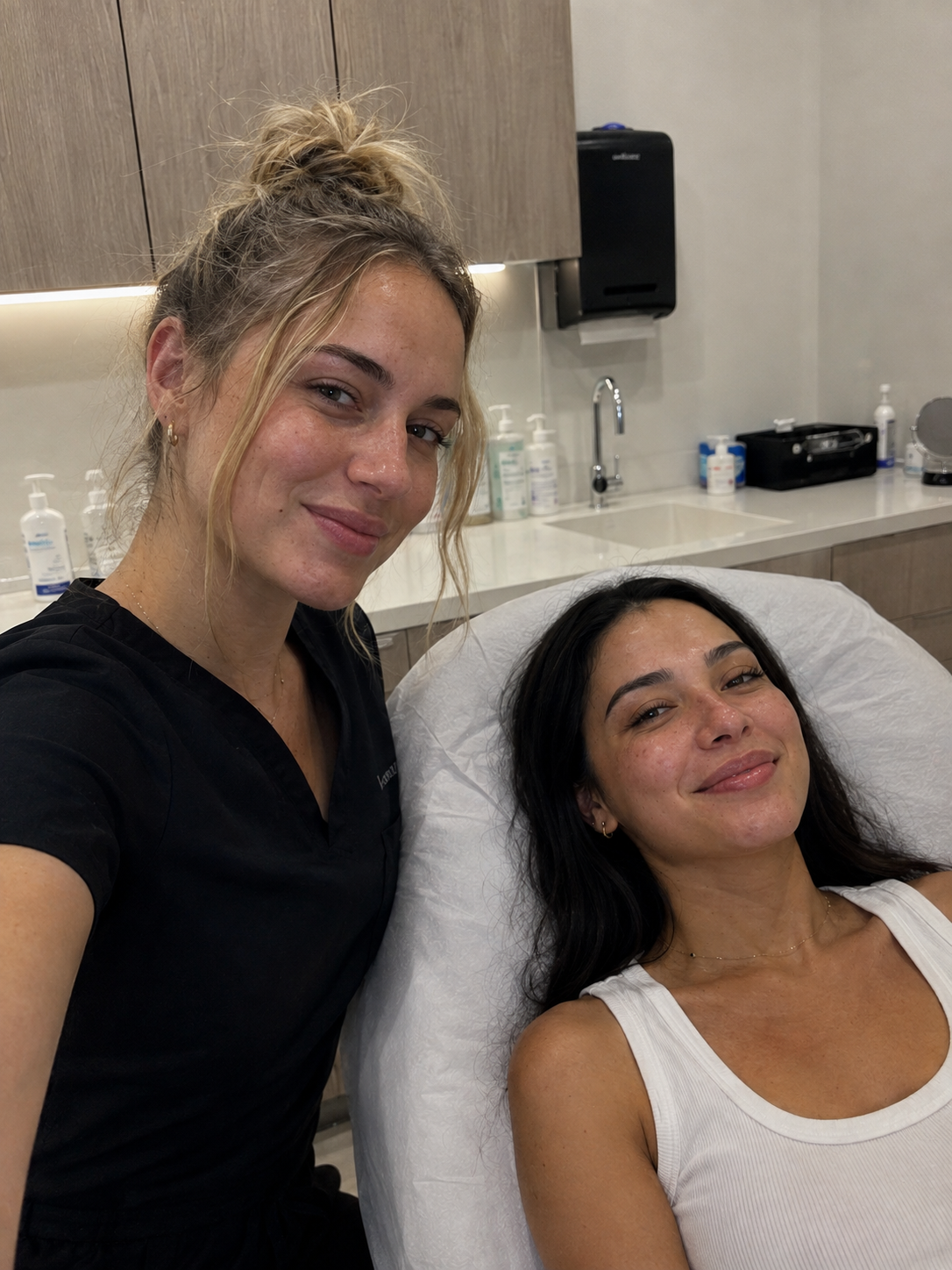 Aesthetician with a happy patient in the treatment chair